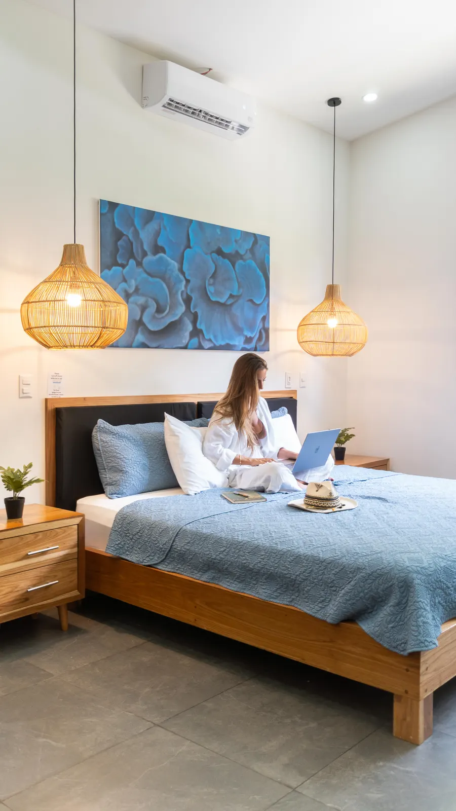 Woman working on a laptop on the bed